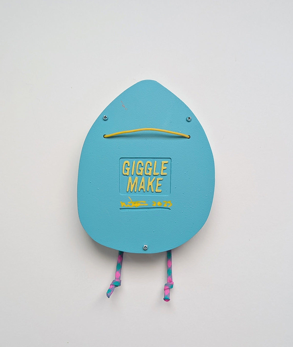 A rear view of a light blue in color hoodie style wall sculpture that depicts hanging hardware shown with a white background.