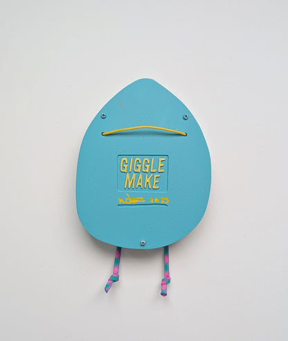 A rear view of a light blue in color hoodie style wall sculpture that depicts hanging hardware shown with a white background.
