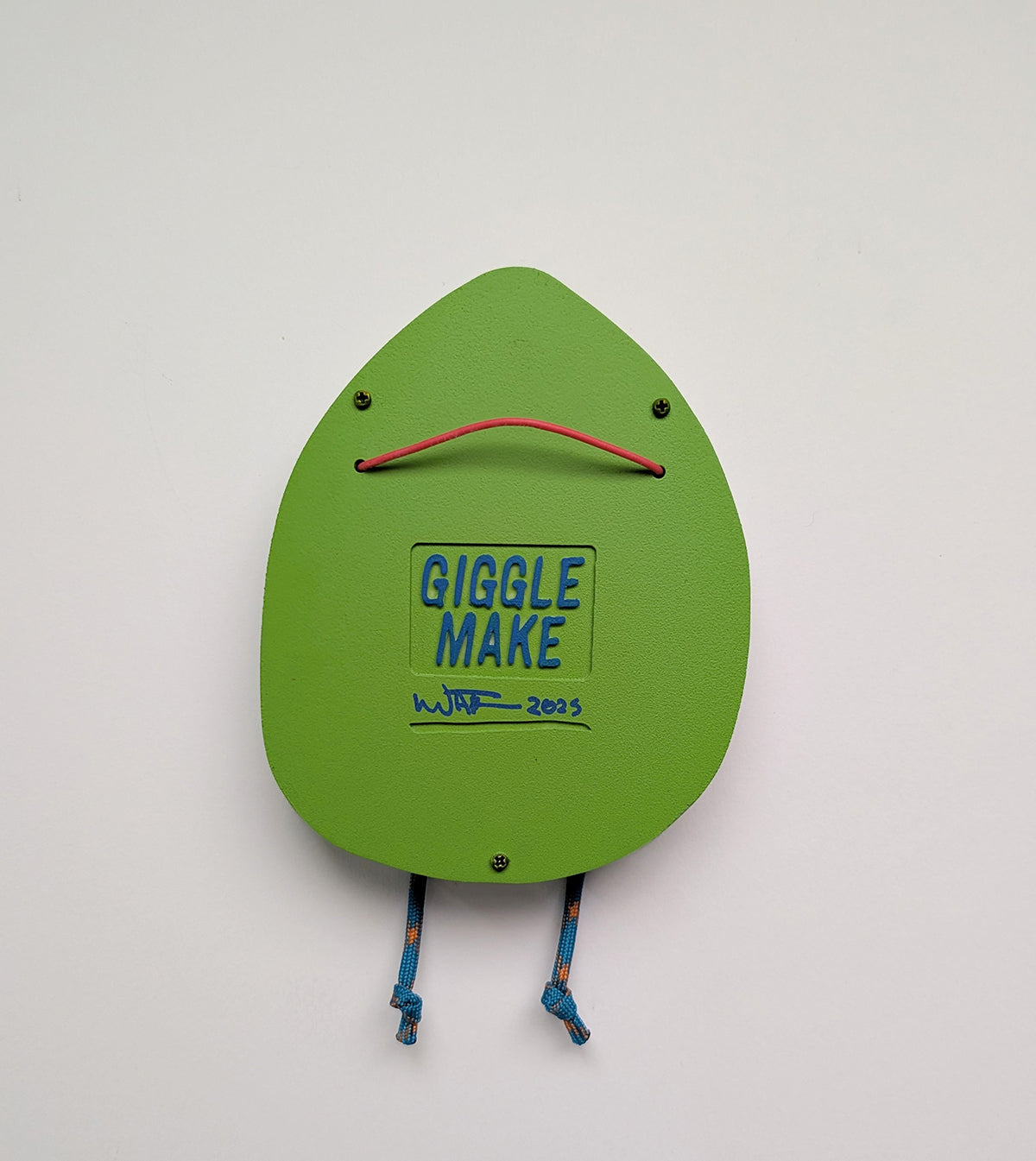A rear view of a yellow green in color hoodie style wall sculpture that depicts hanging hardware shown with a white background.