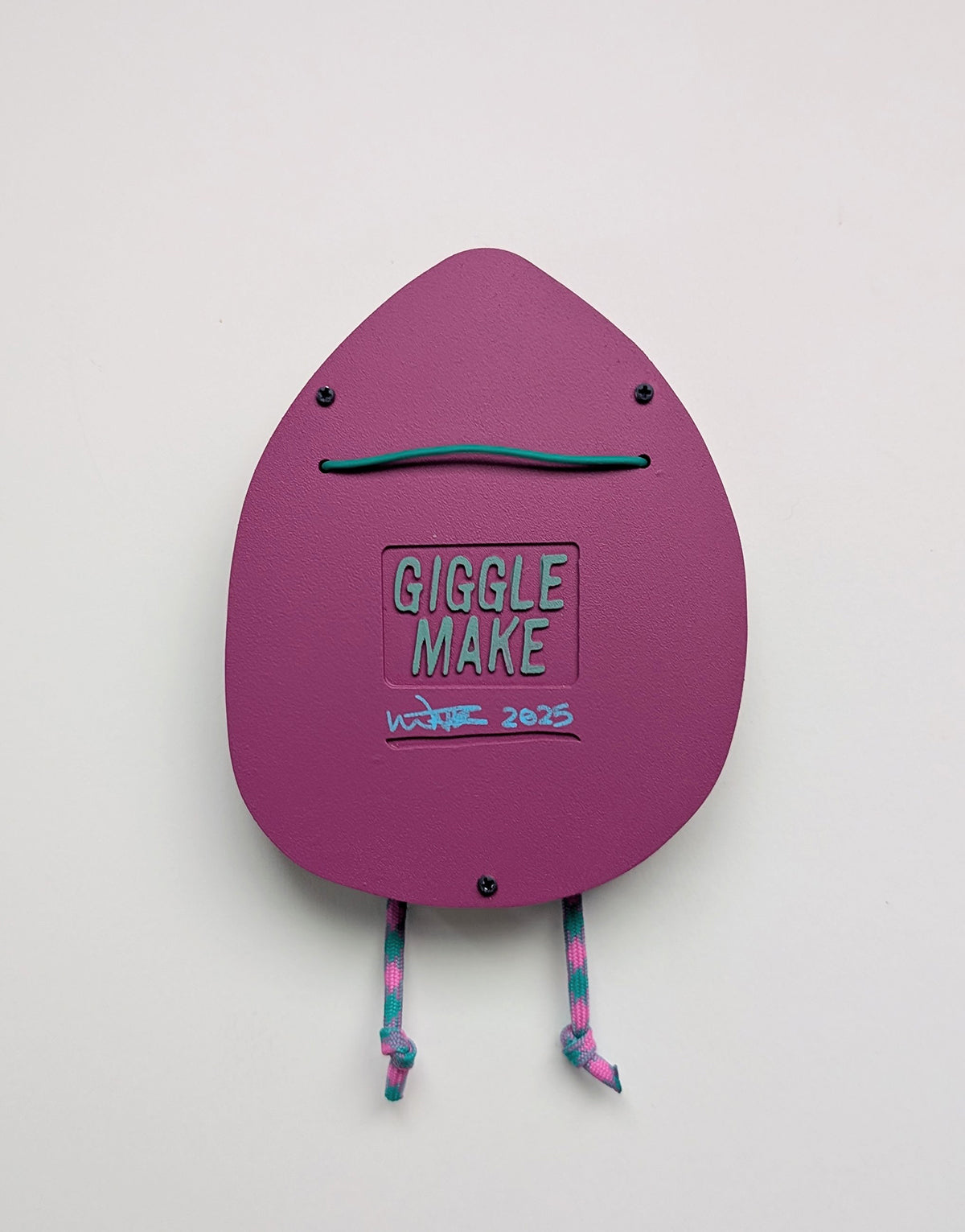 Backside view of a purple hooded wall sculpture that shows wall hanging hardware on a white background.